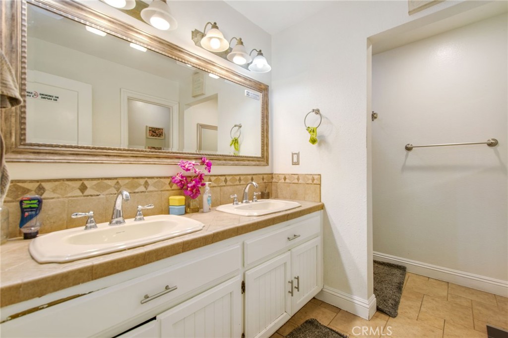 7241 Old Temescal Road Corona, CA 92881 - Photo 16 of 47 a bathroom with a sink double vanity granite and a mirror