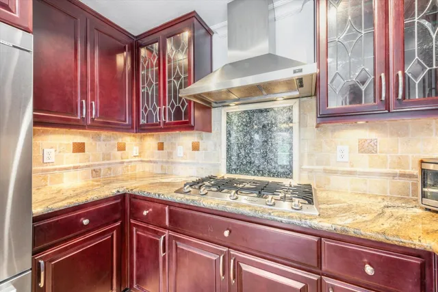 a kitchen with granite countertop wooden cabinets and a counter top space