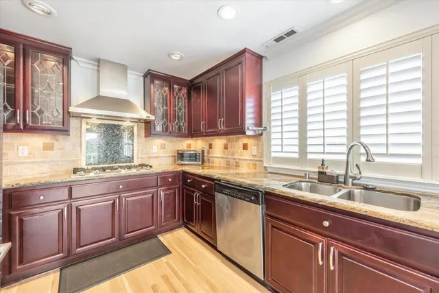 a kitchen with a sink stove and cabinets