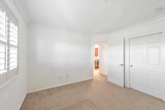 an empty room with windows and closet