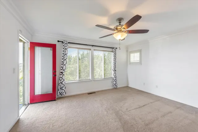 a view of room with window and ceiling fan