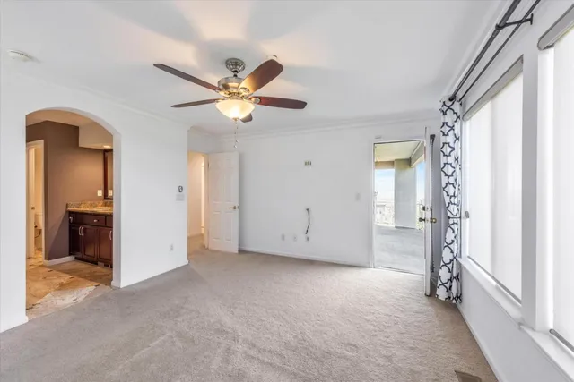 a view of a livingroom with a ceiling fan and window