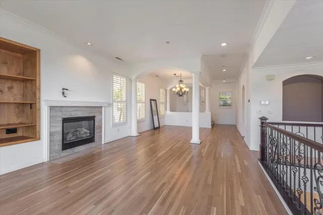 a view of a room with wooden floor and a fireplace