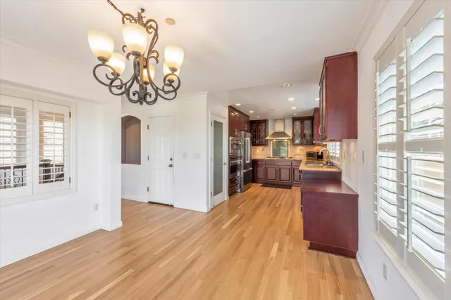 a view of a dining room with furniture wooden floor and chandelier