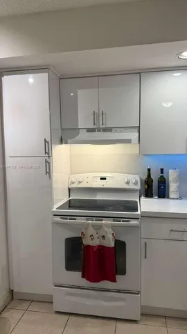 a stove top oven sitting inside of a kitchen