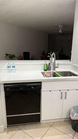 a close view of a sink and a stove in a kitchen