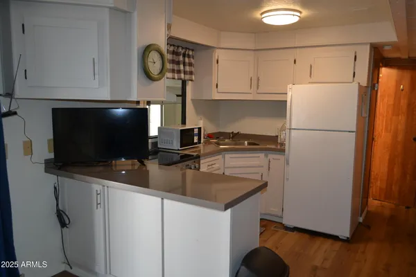 a kitchen with appliances a sink and a stove