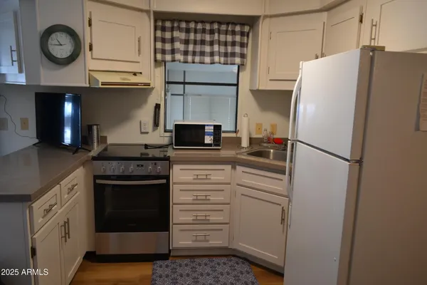 a kitchen with a refrigerator and a stove