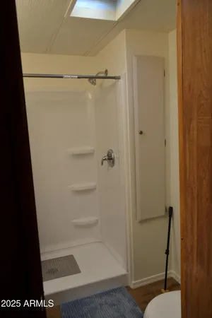 a bathroom with a glass shower door