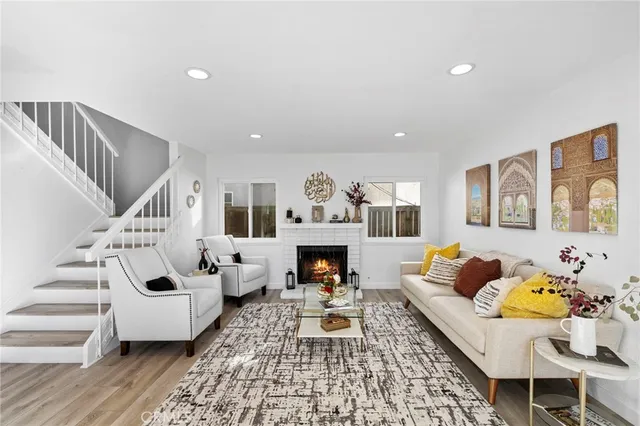 a living room with furniture fireplace and rug