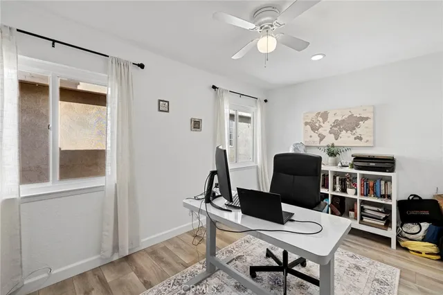 a view of a workspace with furniture and a window