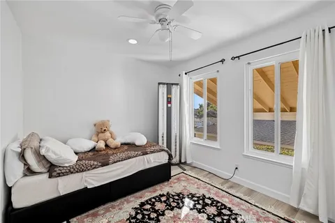 a bedroom with a bed and wooden floor