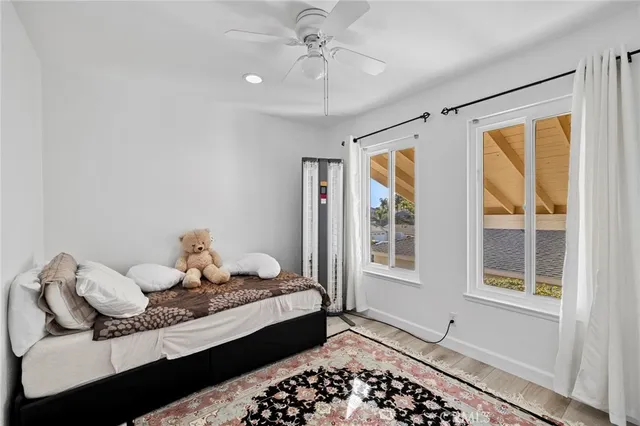a bedroom with a bed and wooden floor