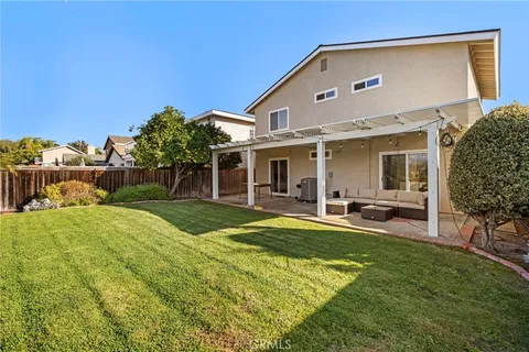 a front view of house with yard and outdoor seating