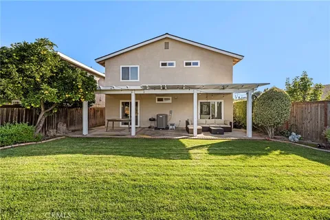 a view of a house with swimming pool and a yard