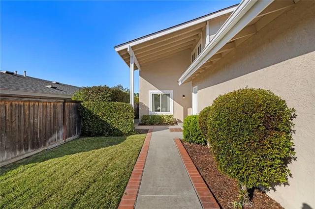 a view of a house with a small yard and plants