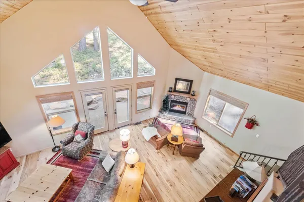 a living room with furniture and floor to ceiling windows