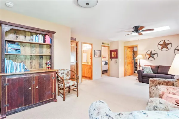 a living room with furniture and book shelf