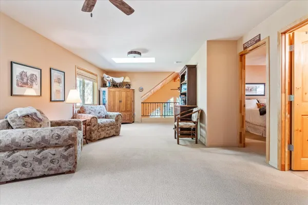 a bedroom with furniture and a ceiling fan