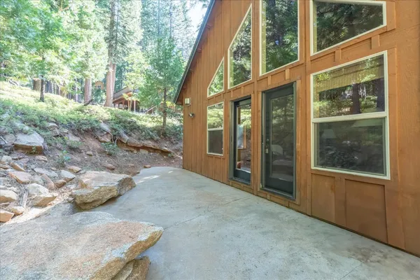 a backyard of a house with yard and outdoor seating