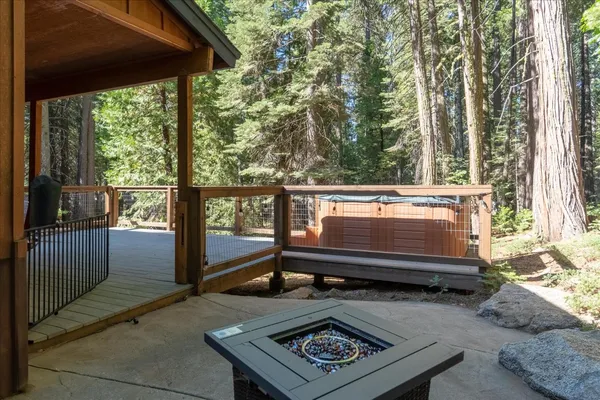 a view of a balcony with wooden floor and fence