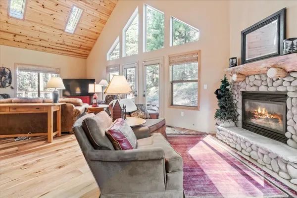 a living room with furniture a large window and a fireplace