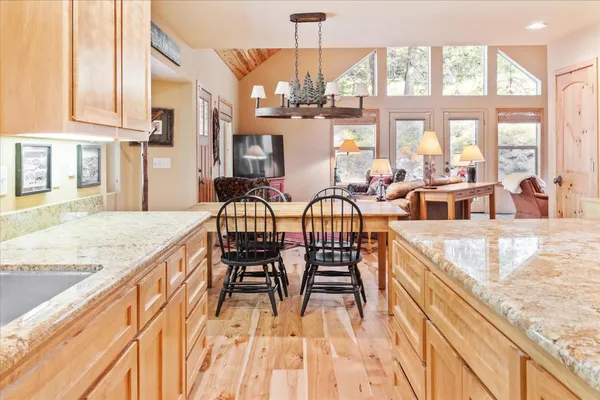 a view of a kitchen with dining room and windows