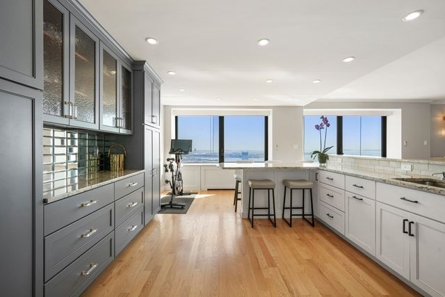 a kitchen with refrigerator and chairs