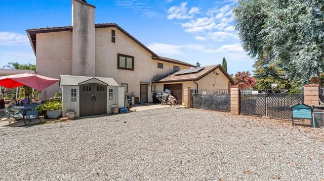 a view of a house with backyard and sitting area