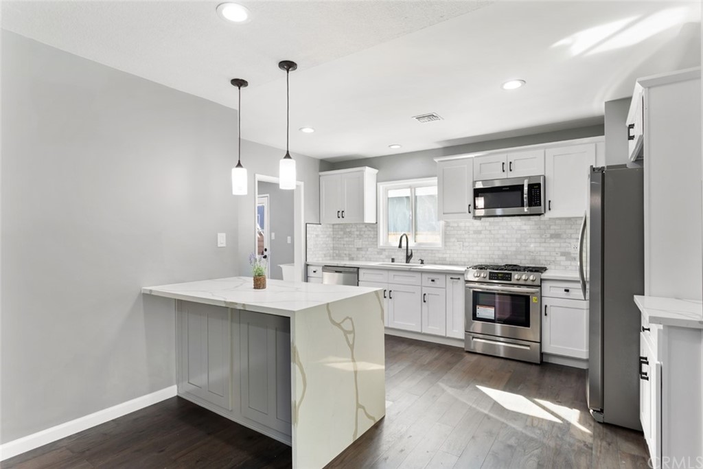 421 Catalpa Avenue Brea, CA 92821 - Photo 9 of 27 a view of a kitchen cabinets a sink dishwasher a refrigerator and wooden floor