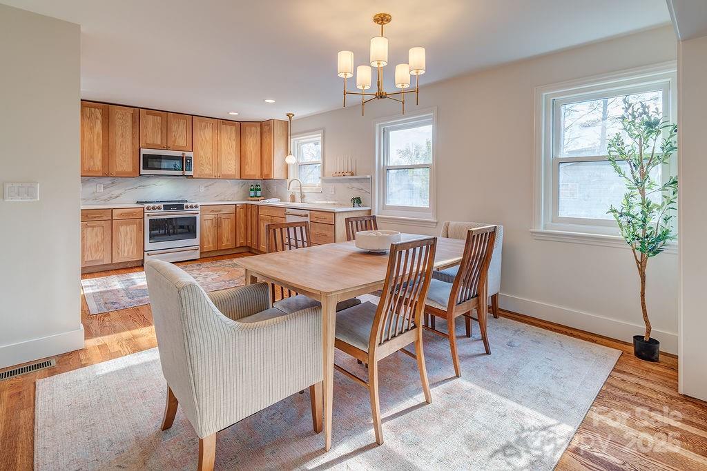 55 Cisco Road Asheville, NC 28805 - Photo 11 of 38 a view of a dining room with furniture window and wooden floor
