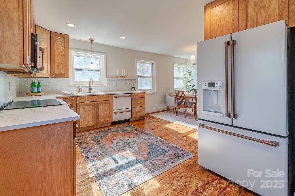 55 Cisco Road Asheville, NC 28805 - Photo 14 of 38 a large kitchen with stainless steel appliances granite countertop a refrigerator and a stove top oven