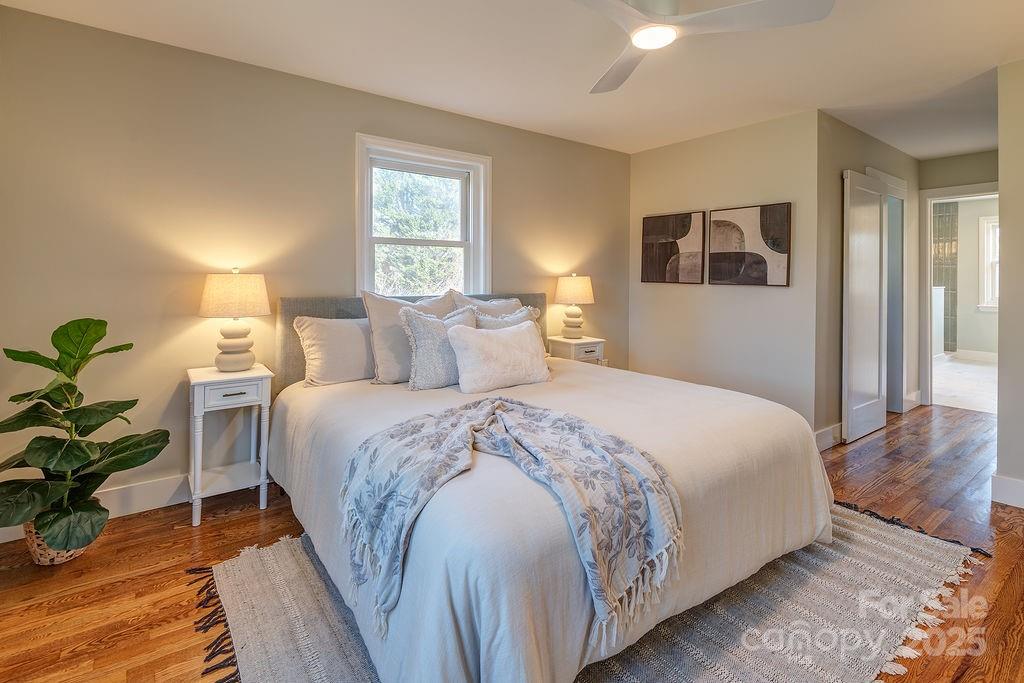 55 Cisco Road Asheville, NC 28805 - Photo 18 of 38 a bedroom with a bed and wooden floor