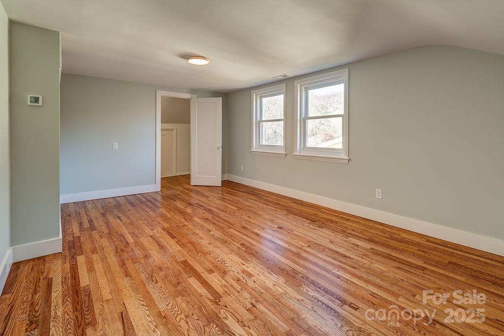 55 Cisco Road Asheville, NC 28805 - Photo 22 of 38 a view of an empty room with wooden floor and a window