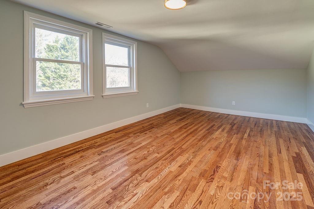 55 Cisco Road Asheville, NC 28805 - Photo 23 of 38 an empty room with wooden floor and windows