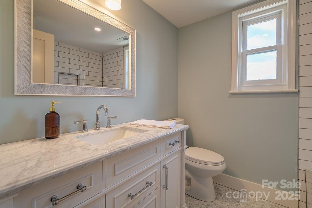 55 Cisco Road Asheville, NC 28805 - Photo 24 of 38 a bathroom with a granite countertop toilet sink and mirror