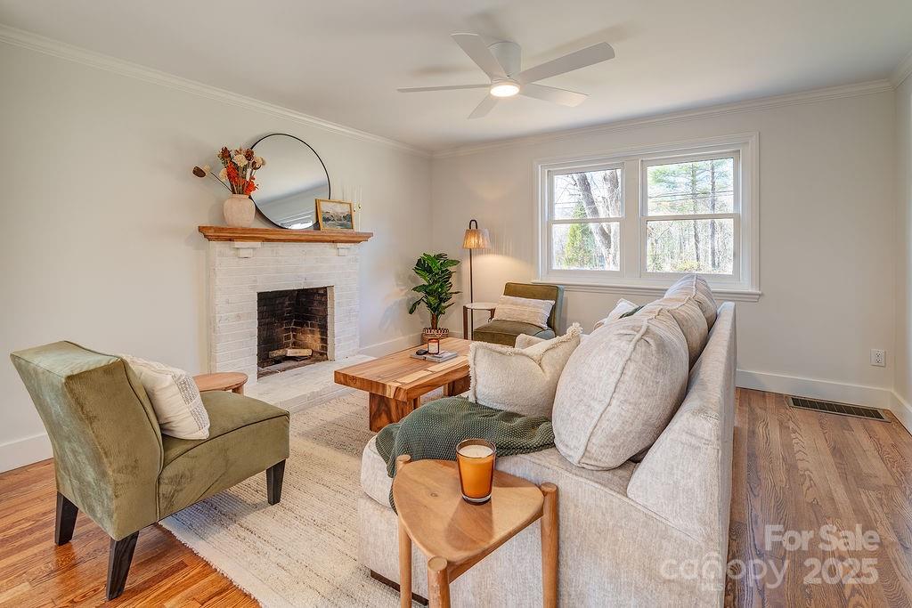 55 Cisco Road Asheville, NC 28805 - Photo 6 of 38 a living room with furniture a fireplace and a window