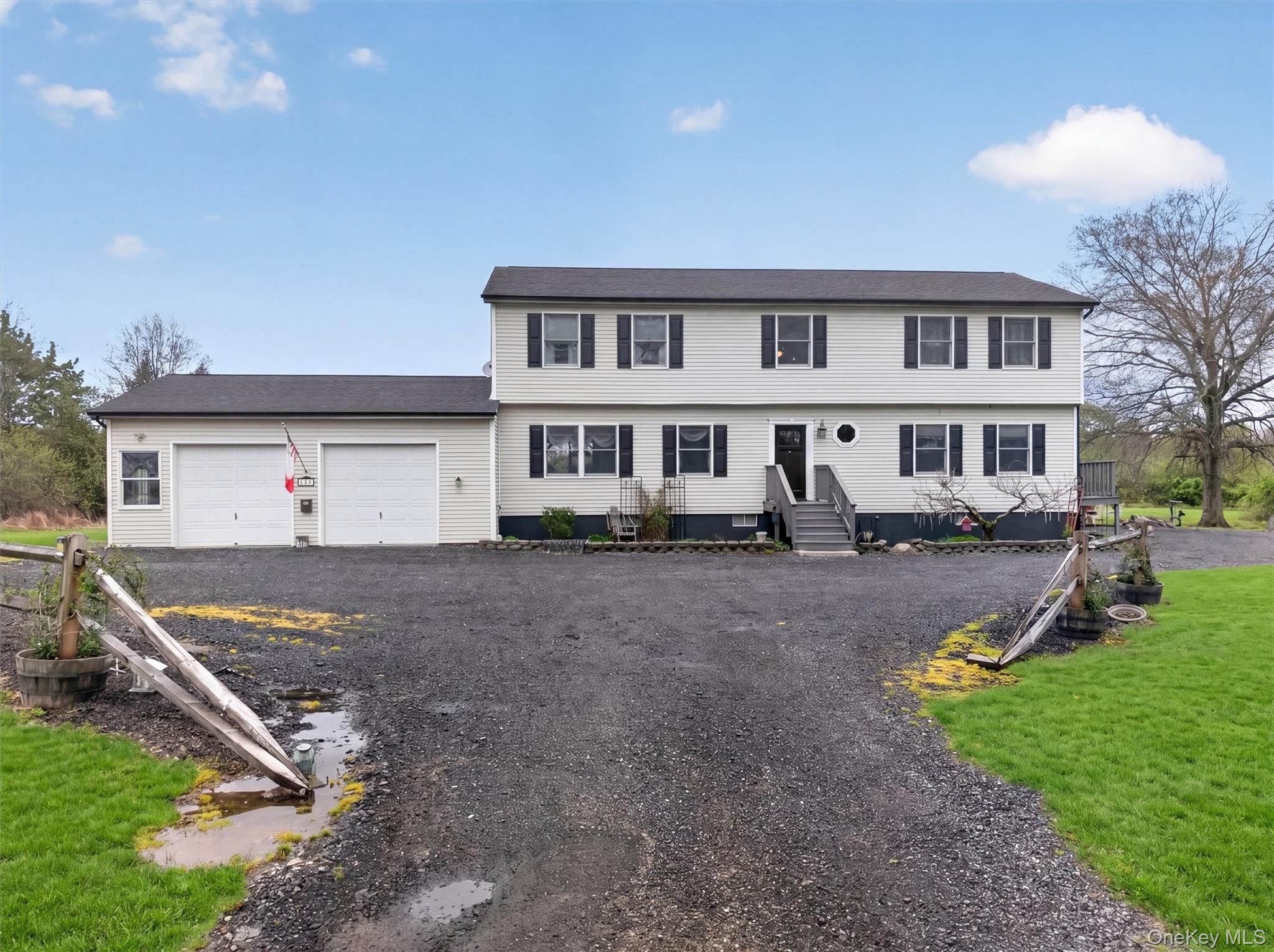 a front view of a house with a yard and trees