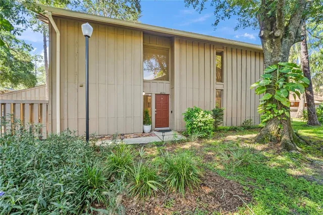a view of a house with a yard and plants