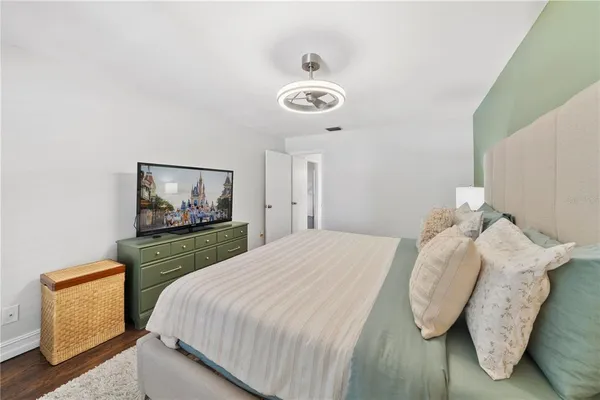 a bedroom with a bed and painting on the wall