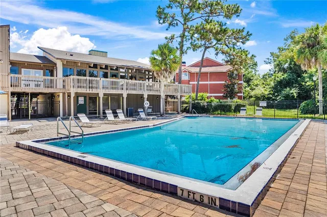a view of swimming pool with a garden and plants