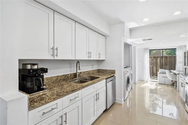 a kitchen with a sink and cabinets