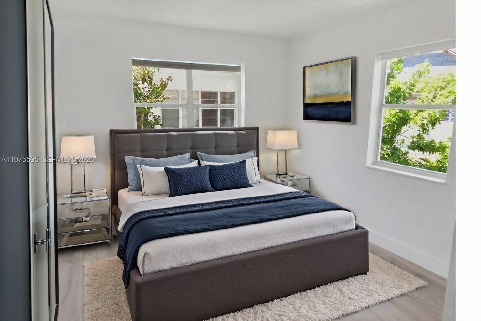 1000 7th Street Miami Beach, FL 33139 - Photo 11 of 36 a bed sitting in a bedroom next to a window