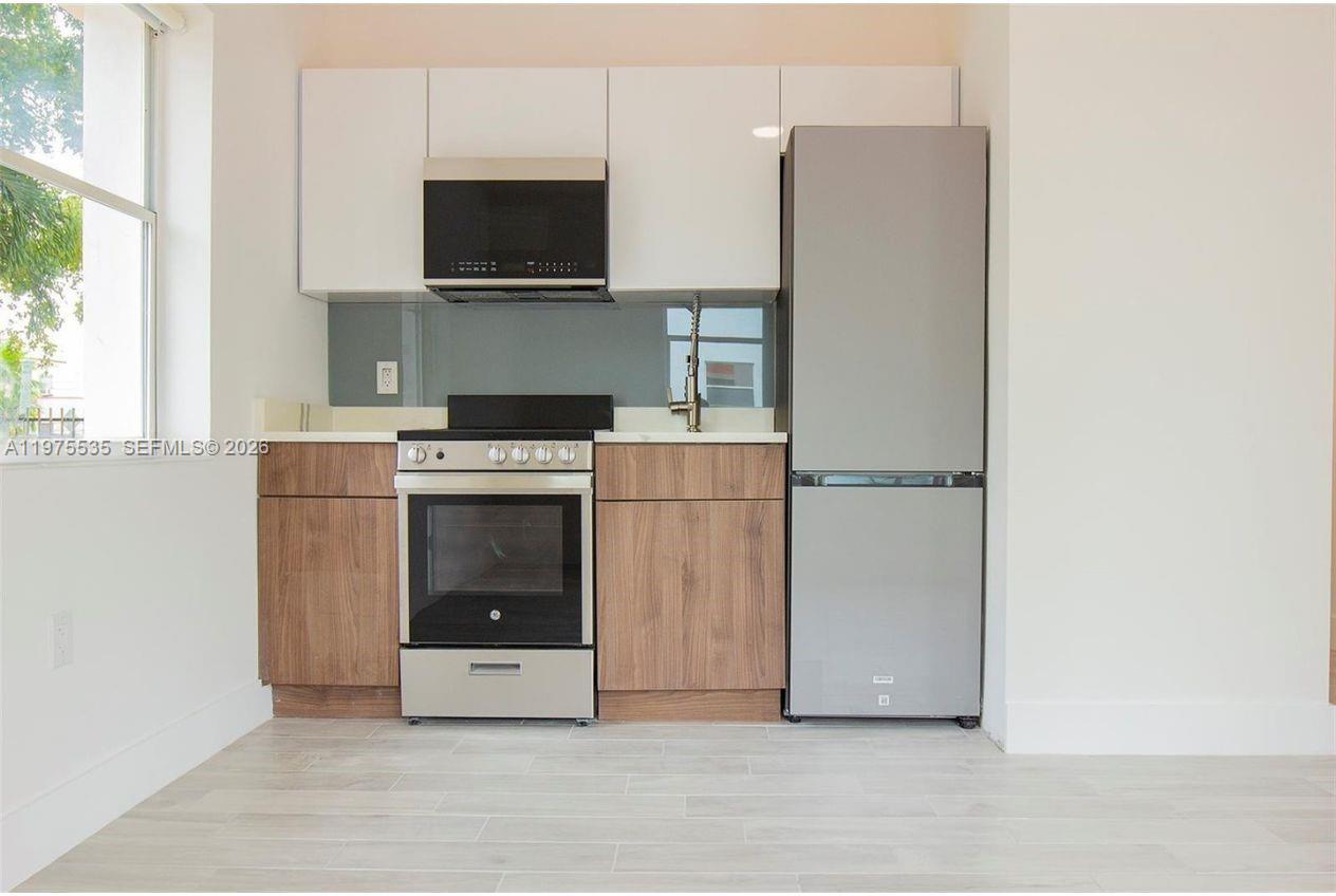 1000 7th Street Miami Beach, FL 33139 - Photo 18 of 36 a kitchen with a stove and a refrigerator