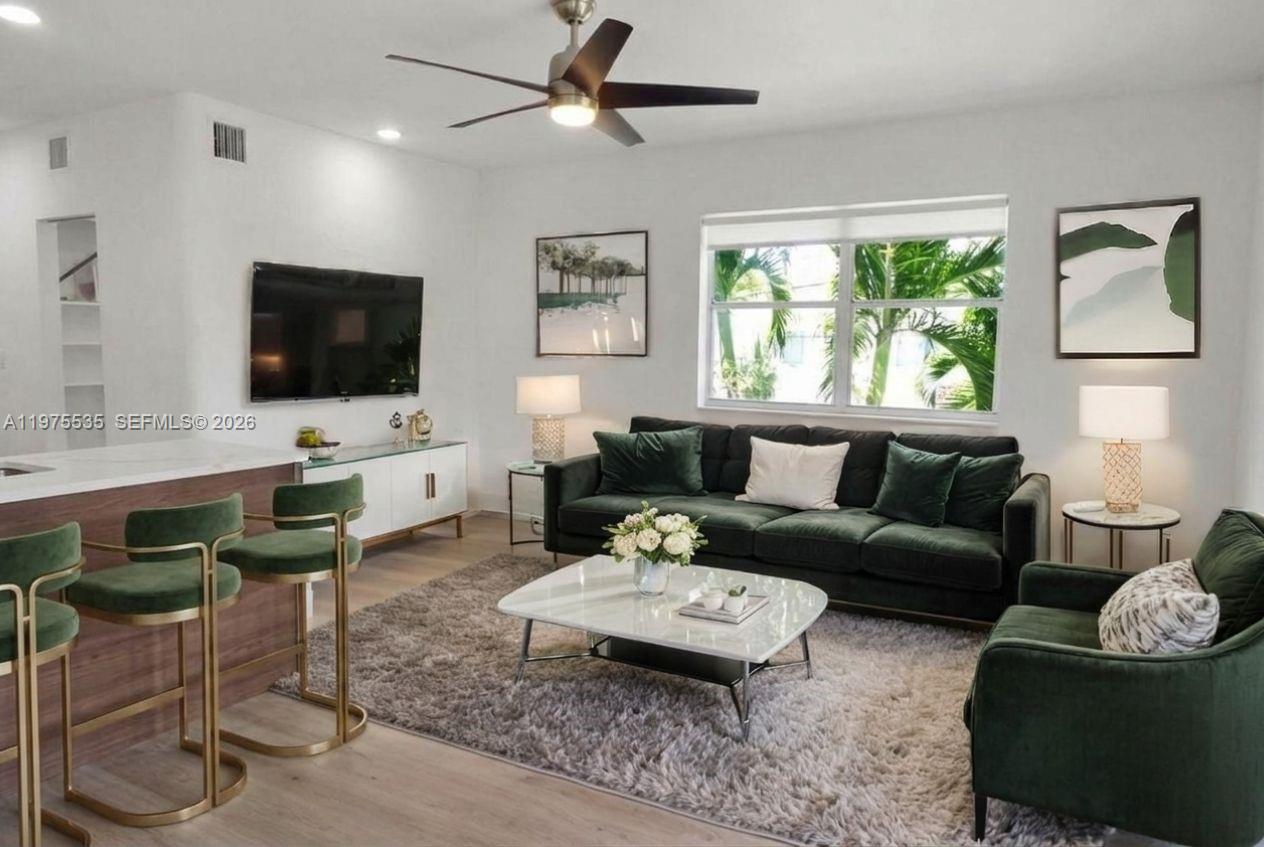 1000 7th Street Miami Beach, FL 33139 - Photo 8 of 36 a living room with furniture and a flat screen tv