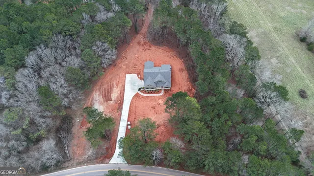 an aerial view of a house with outdoor space