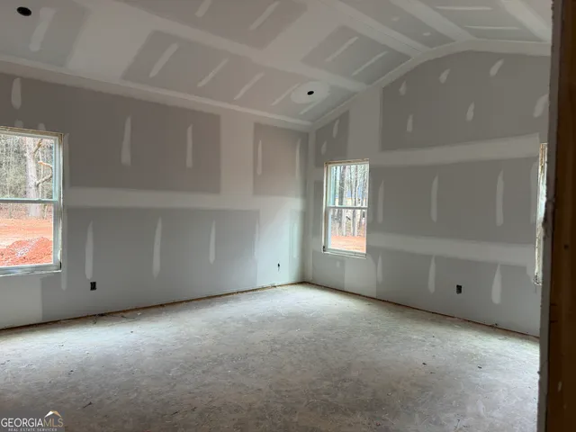 a view of a room with a refrigerator and window
