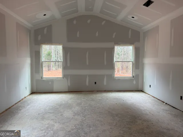 a view of empty room with a fireplace