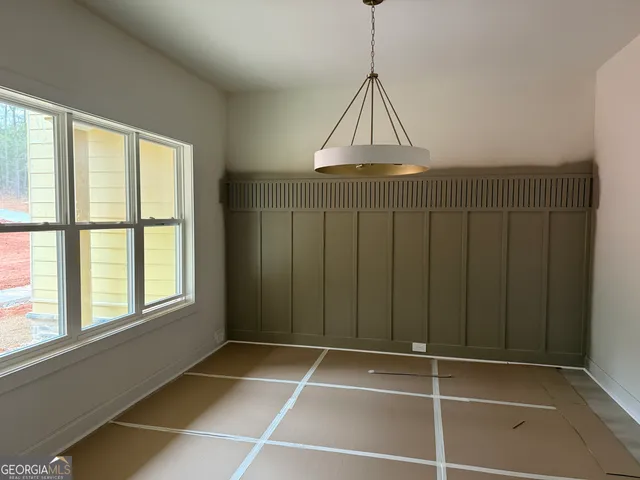a room with a window and chandelier