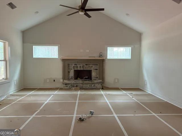 a view of an empty room with a fireplace